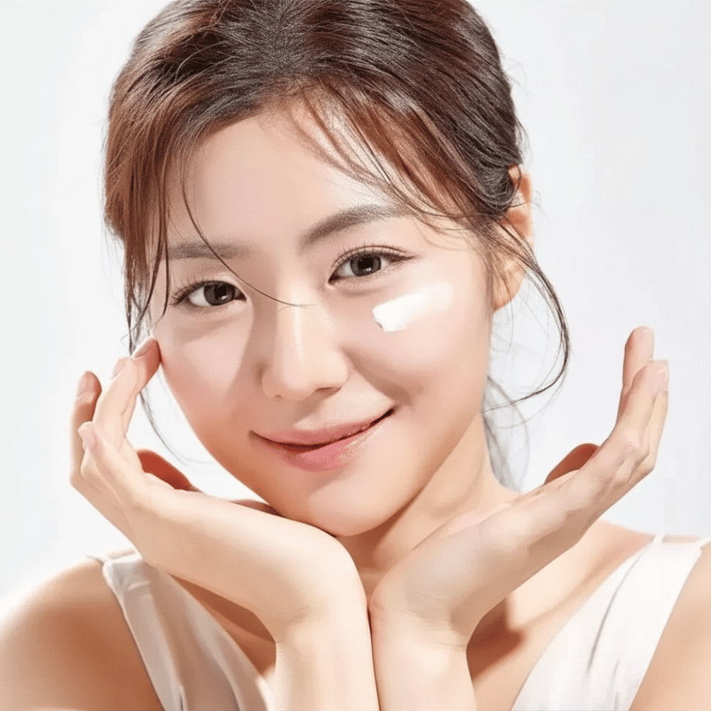 Woman applies Round Lab 1025 Dokdo Eye Cream under the eyes for hydration, radiance, and a more even skin tone
