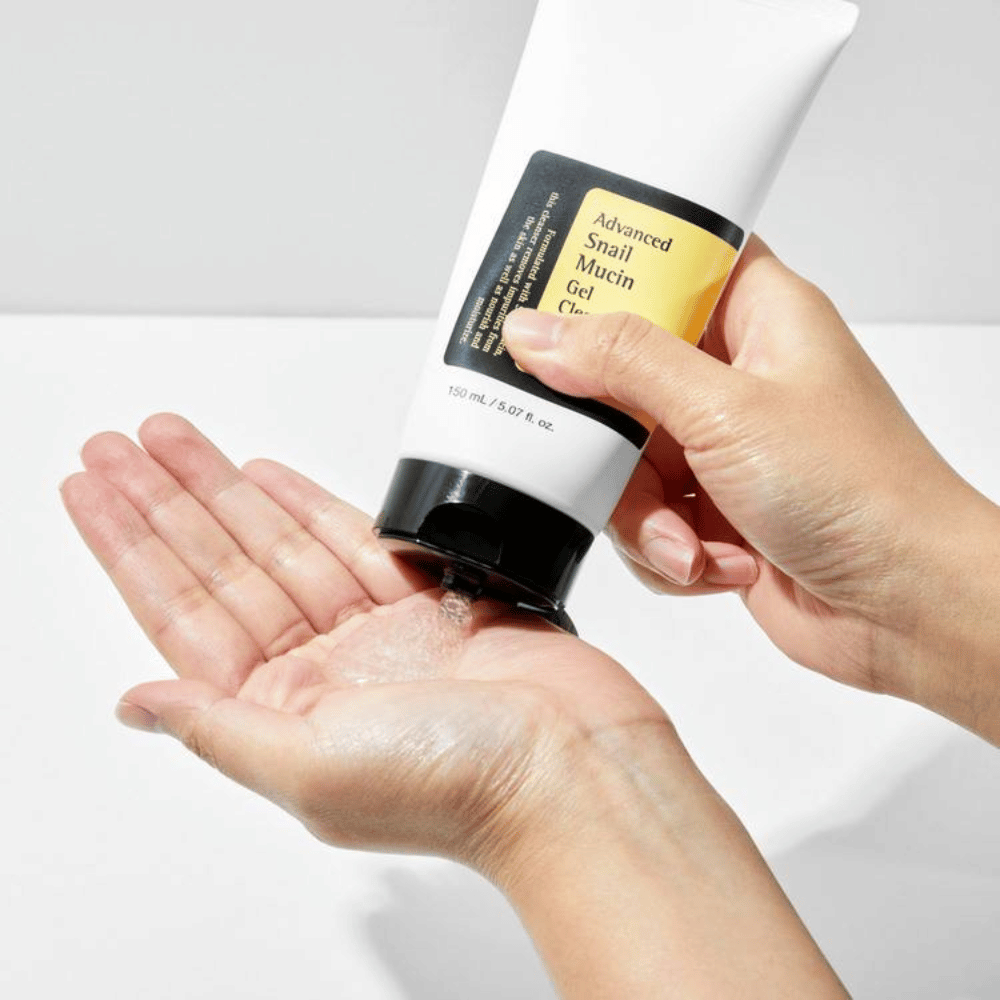 Hand applies COSRX Advanced Snail Mucin Gel Cleanser – gentle gel cleanser with snail mucin that cleanses deeply and maintains the skin's moisture balance.