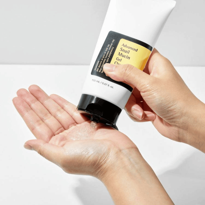 Hand applies COSRX Advanced Snail Mucin Gel Cleanser – gentle gel cleanser with snail mucin that cleanses deeply and maintains the skin's moisture balance.