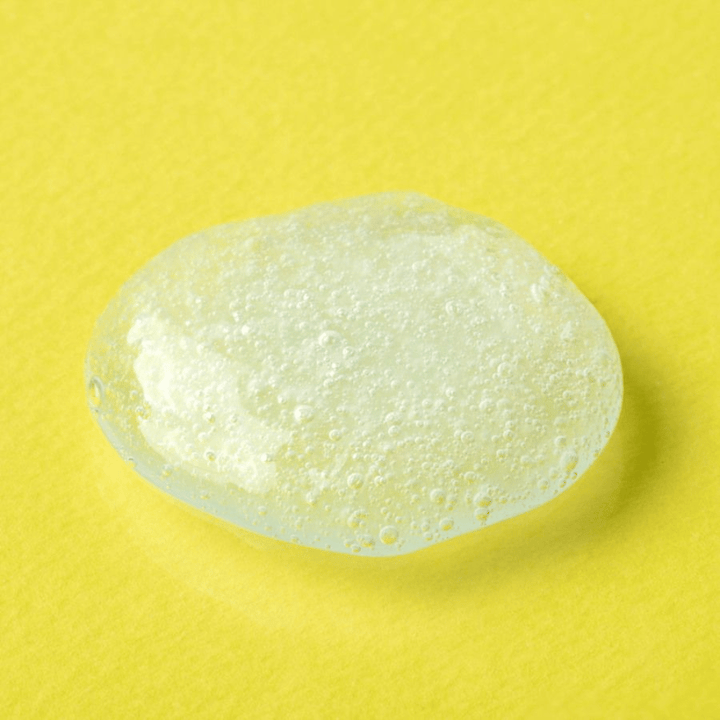 Transparent gel texture from COSRX Advanced Snail Mucin Gel Cleanser on a yellow background – moisturizing face wash with snail secretion for soft and balanced skin.