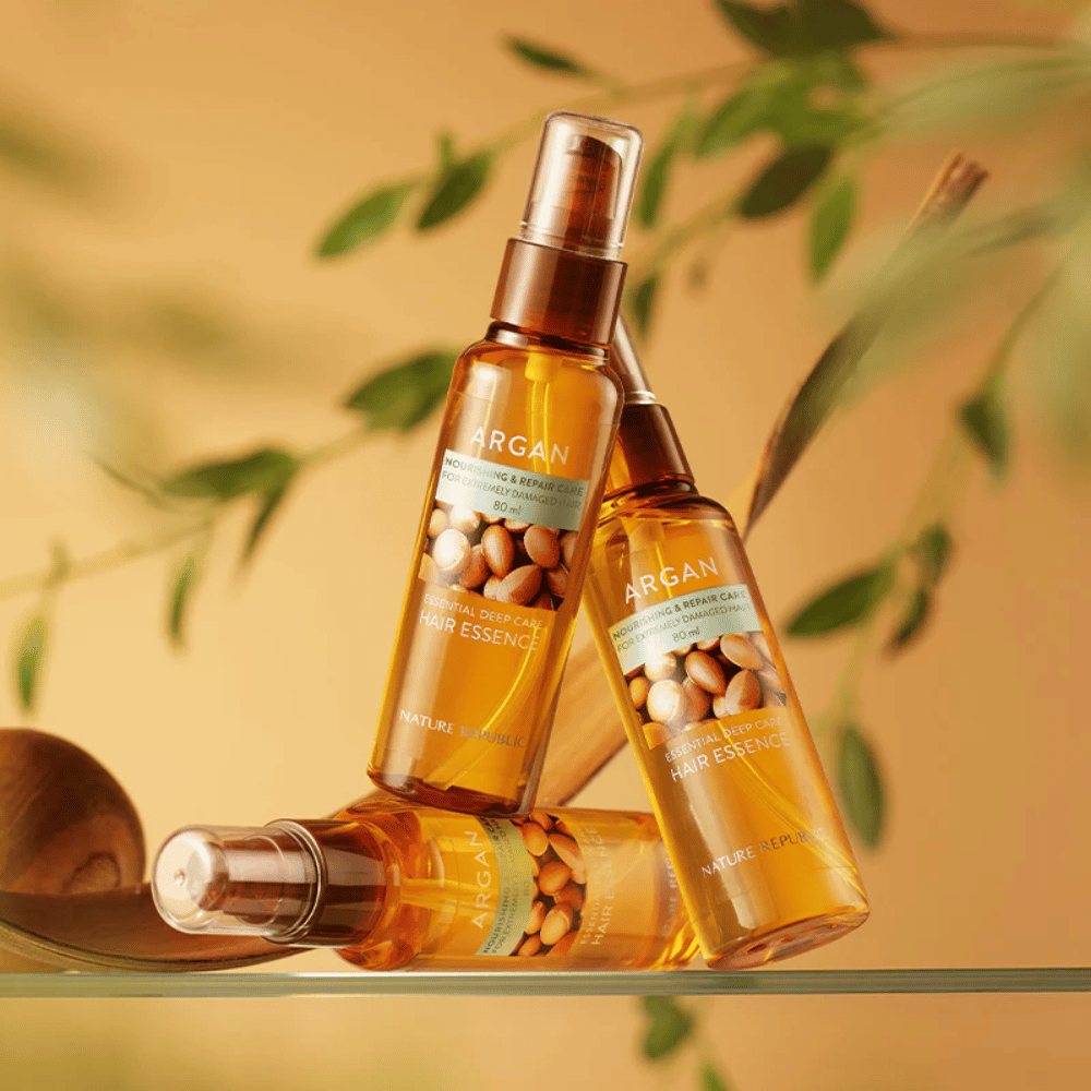 Three bottles of Nature Republic Argan Essential Moisture Hair Oil with argan oil – provides nourishment, shine, and repairs damaged hair.