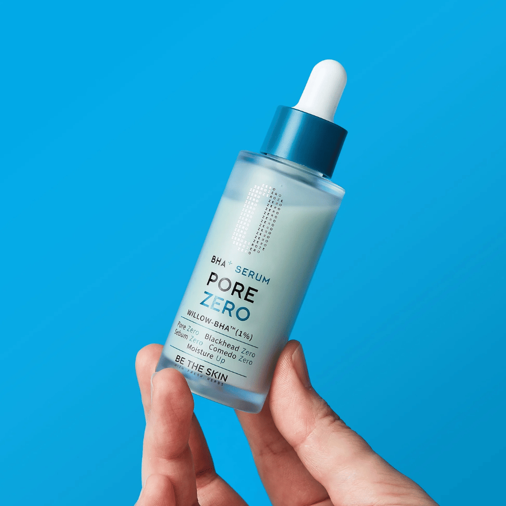 Be The Skin BHA+ Pore Zero Serum held in the hand against a blue background