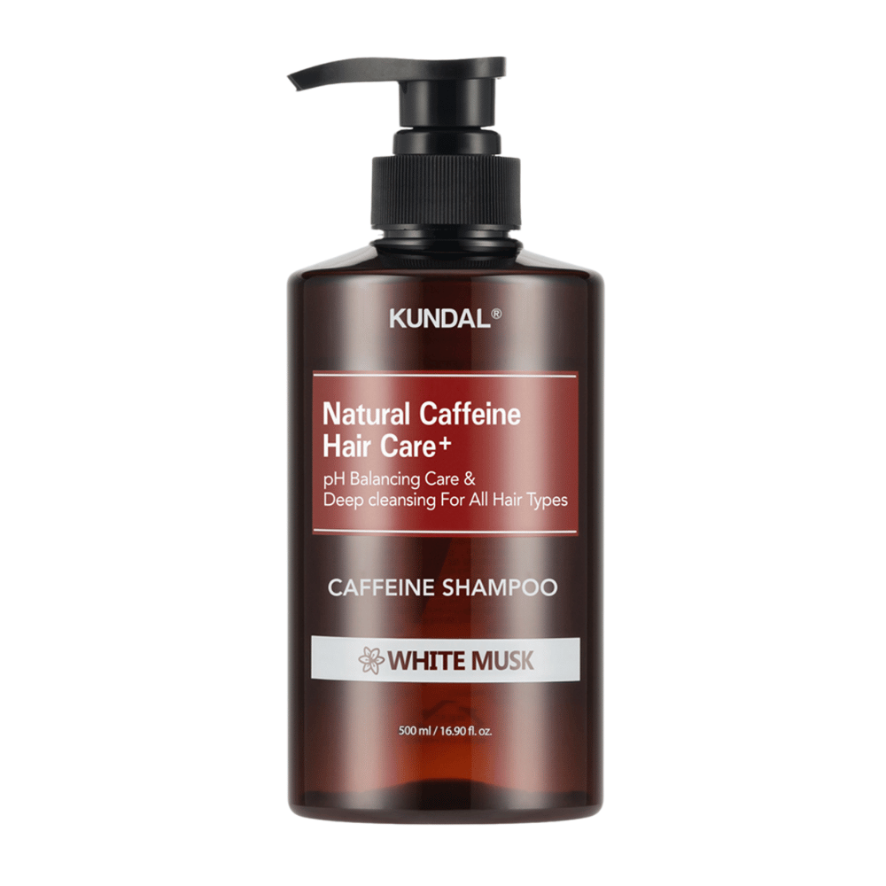 KUNDAL Natural Caffeine Hair Care+ Shampoo White Musk in a brown plastic bottle with pump, 500 ml.