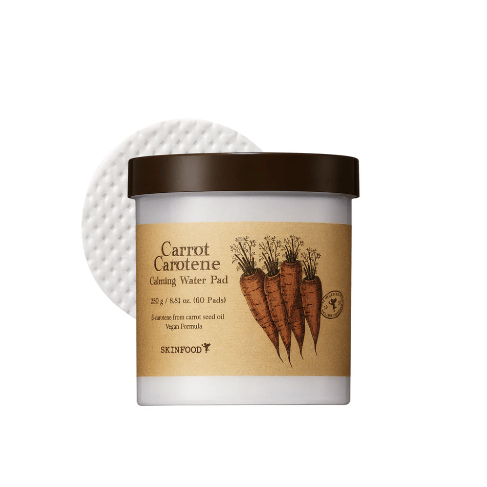 A jar "Carrot Carotene Calming Water Pad" from SKINFOOD. The jar contains 60 pads and is marked with a picture of carrots. The product, which is based on carrot seed oil, is vegan-friendly and designed to soothe the skin.