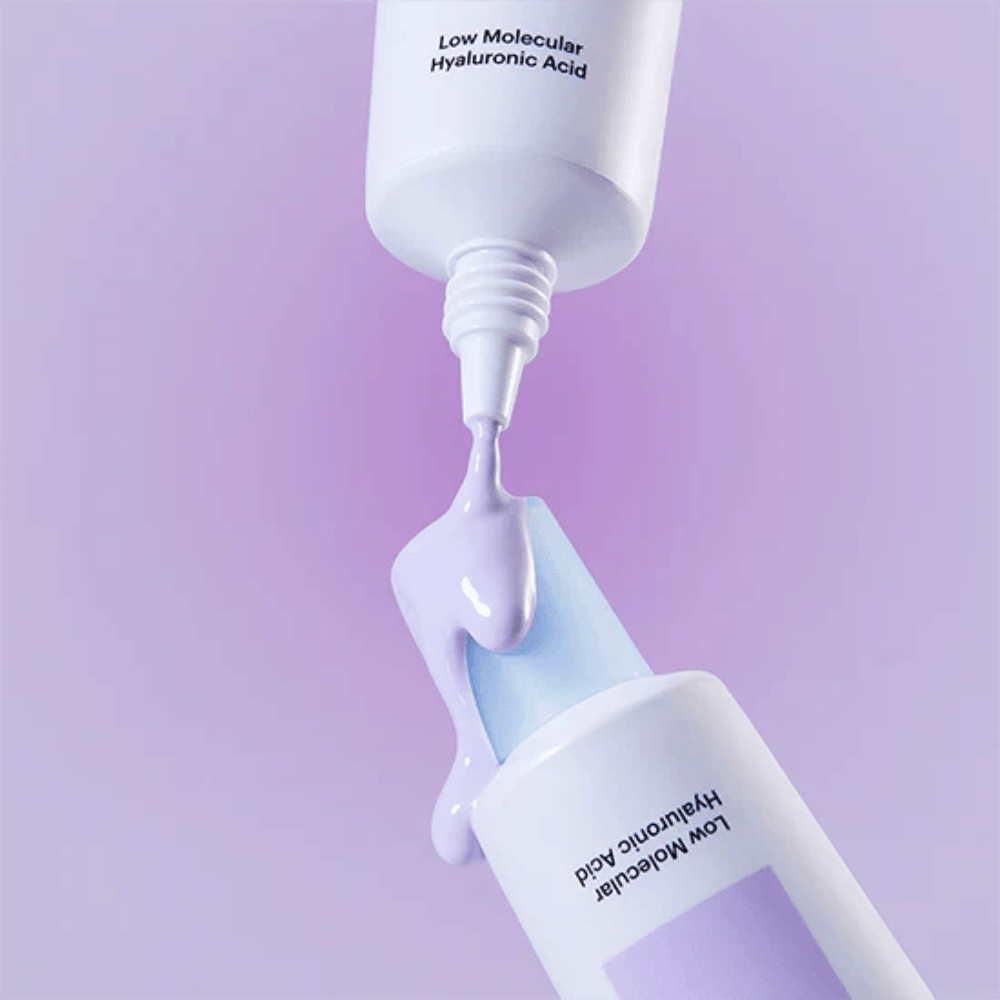 Close-up of Torriden DIVE IN Tone Up Sun Cream Purple where the purple cream is applied from the tube to illustrate the product's consistency.
