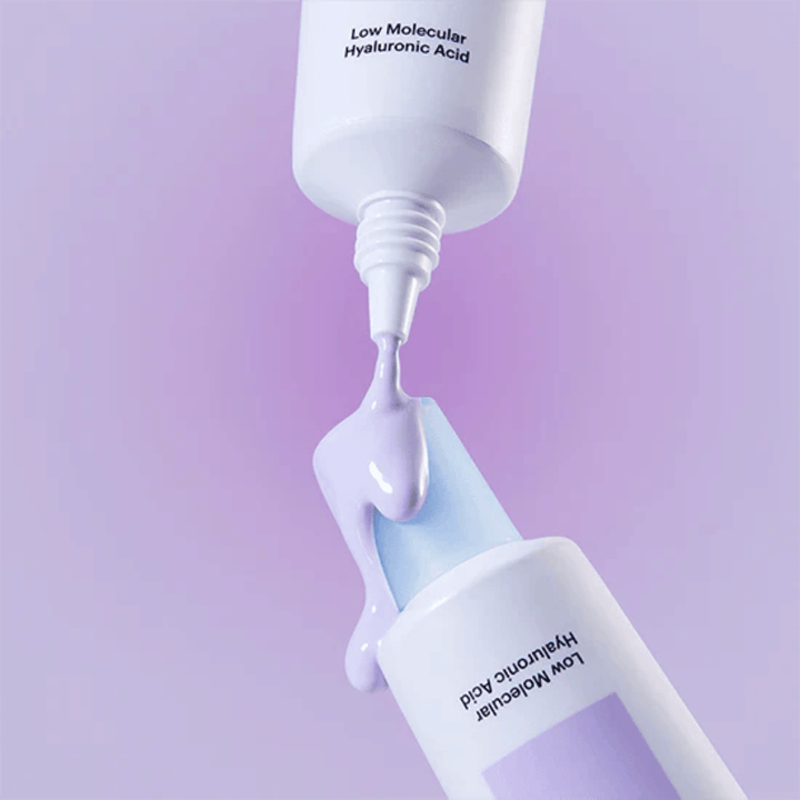 Close-up of Torriden DIVE IN Tone Up Sun Cream Purple where the purple cream is applied from the tube to illustrate the product's consistency.