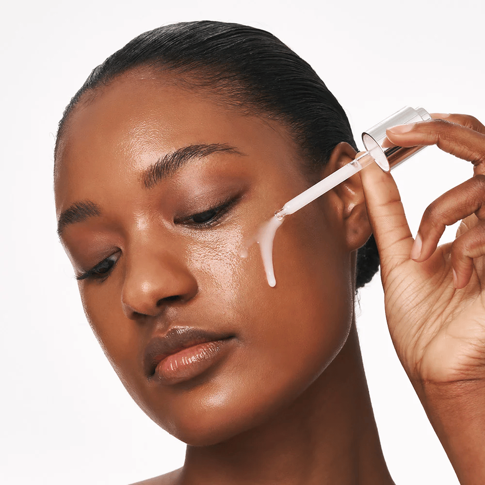 Person applies Deep Collagen Power Boosting Cream in Serum on the cheek with a pipette. The serum gives firmer, hydrated skin with radiance.