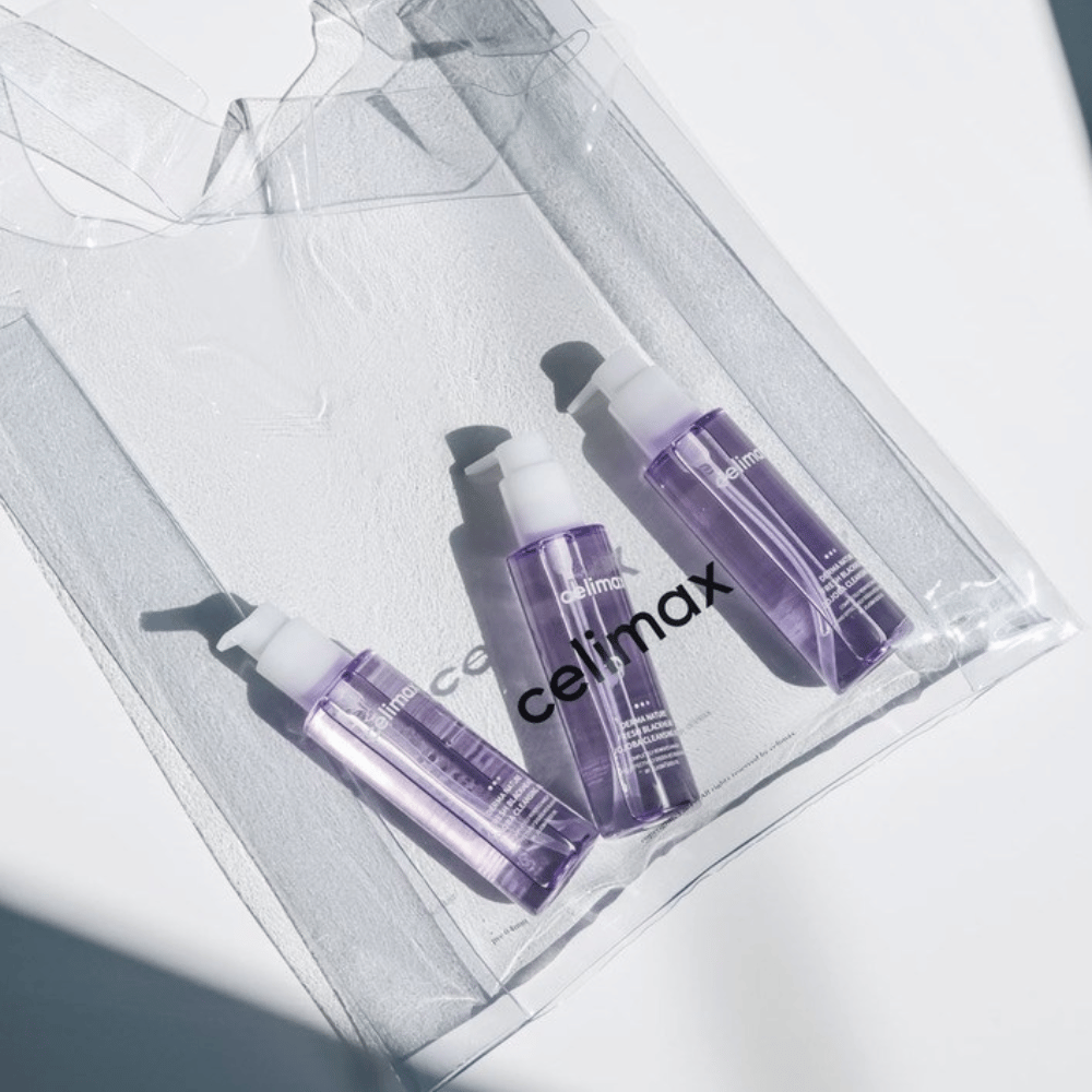 Three bottles of Celimax Derma Nature Fresh Blackhead Jojoba Cleansing Oil in purple packaging, placed in a transparent bag with the logo 'celimax'.