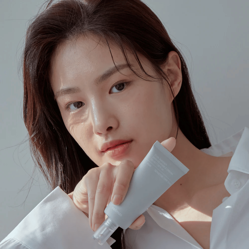 Model holding Celimax Dual Barrier Skin Wearable Cream, soothing and barrier-strengthening face cream for sensitive skin and dry skin.