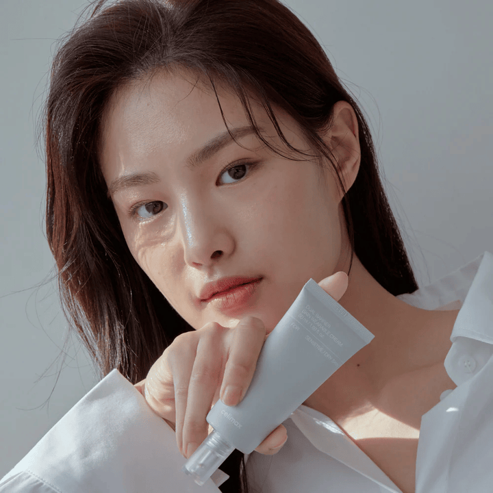 Model holding Celimax Dual Barrier Skin Wearable Cream, soothing and barrier-strengthening face cream for sensitive skin and dry skin.