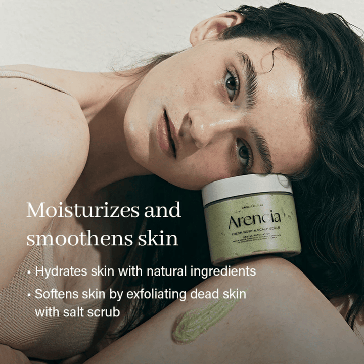 Model resting against Arencia body scrub, moisturizing body scrub that softens the skin and removes dead skin cells.