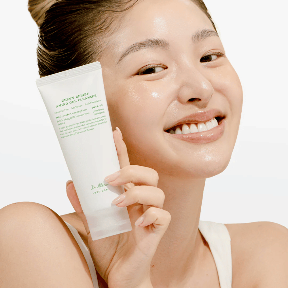 Woman with radiant skin holds up Dr. Althea Green Relief Amino Gel Cleanser – vegan cleansing for sensitive and irritated skin.