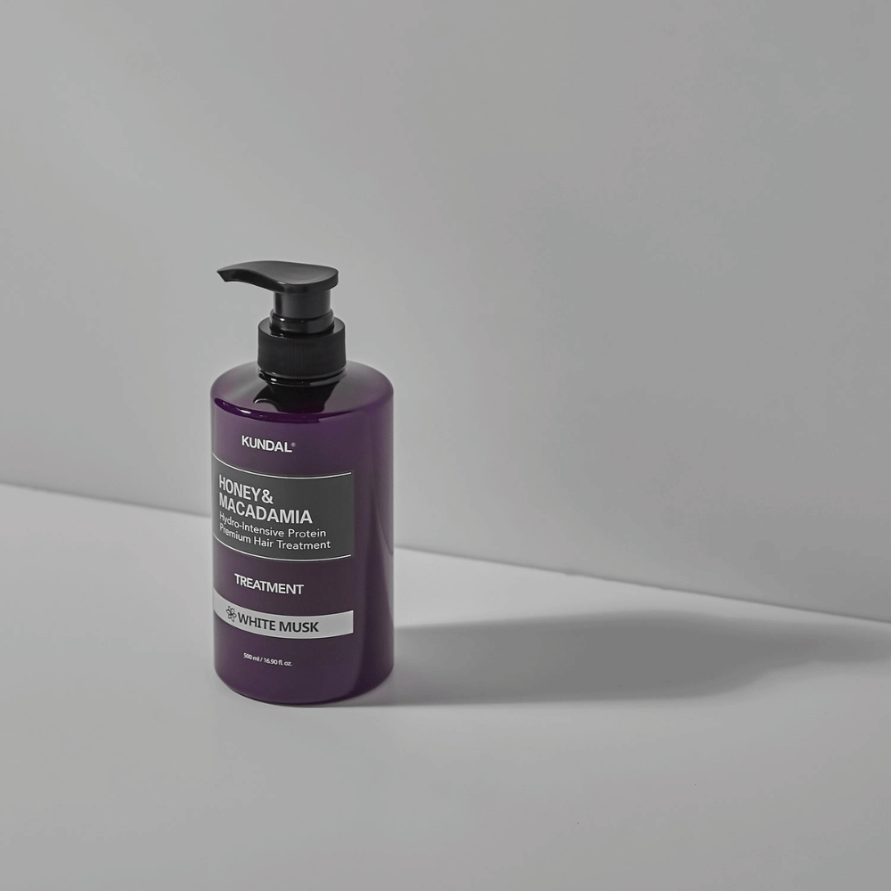 KUNDAL Honey & Macadamia Hydro-Intensive Protein Premium Hair Treatment White Musk in purple pump bottle, 500 ml.