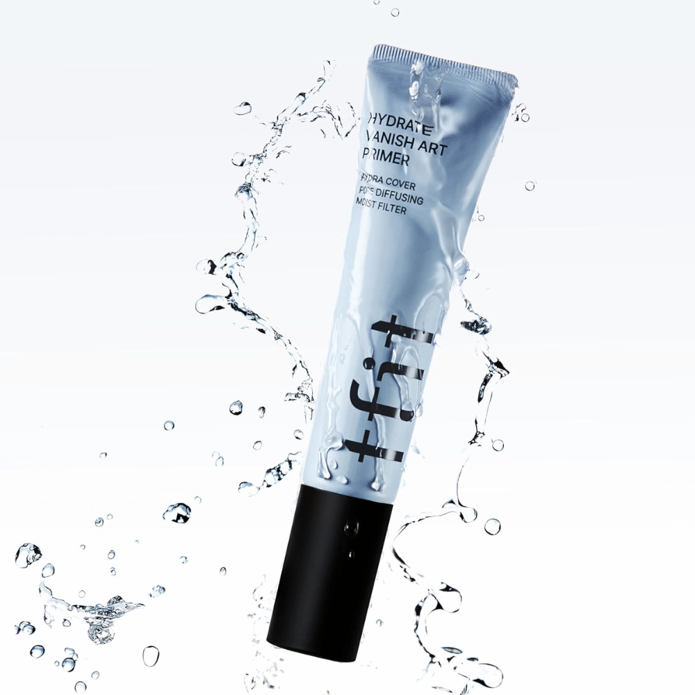 TFIT Hydrate Vanish Art Primer in a blue tube is surrounded by splashing water, symbolizing the product's moisturizing properties and fresh feeling upon application.