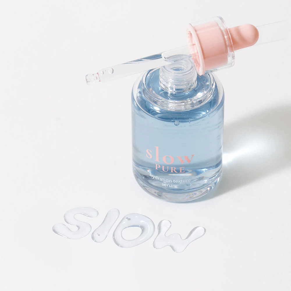 Slow Pure Hydration Texture Serum with an open dropper, text written in serum on the surface: "Slow".