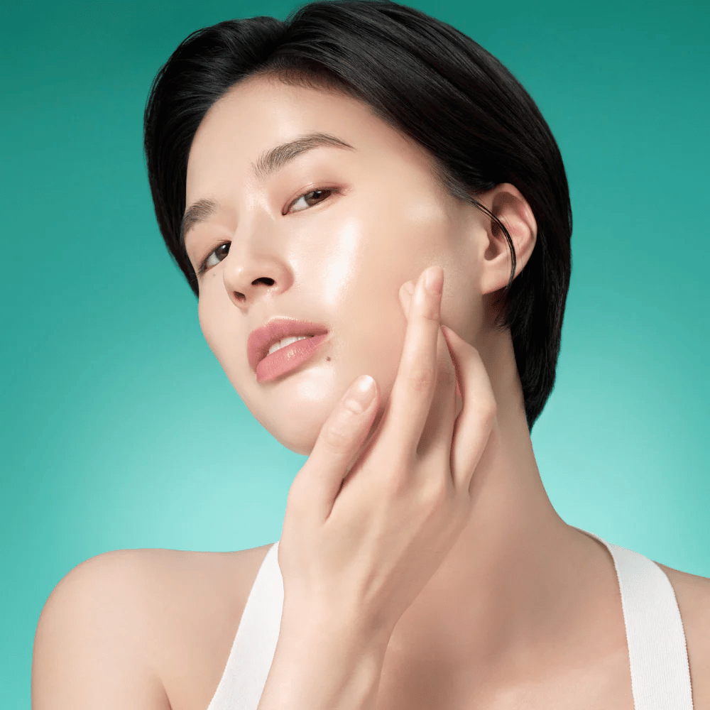 Woman with radiant skin after using Purito Mighty Bamboo Panthenol Serum – soothing and moisturizing serum that strengthens the skin barrier.