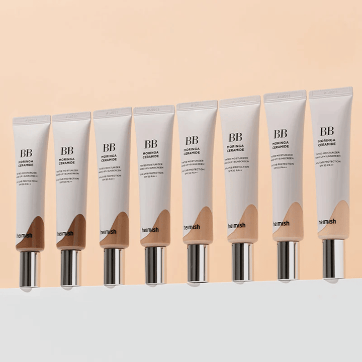 Row of Heimish Moringa Ceramide BB Cream in several color shades. The image illustrates the variation from lighter to darker tones to suit different skin tones and needs.