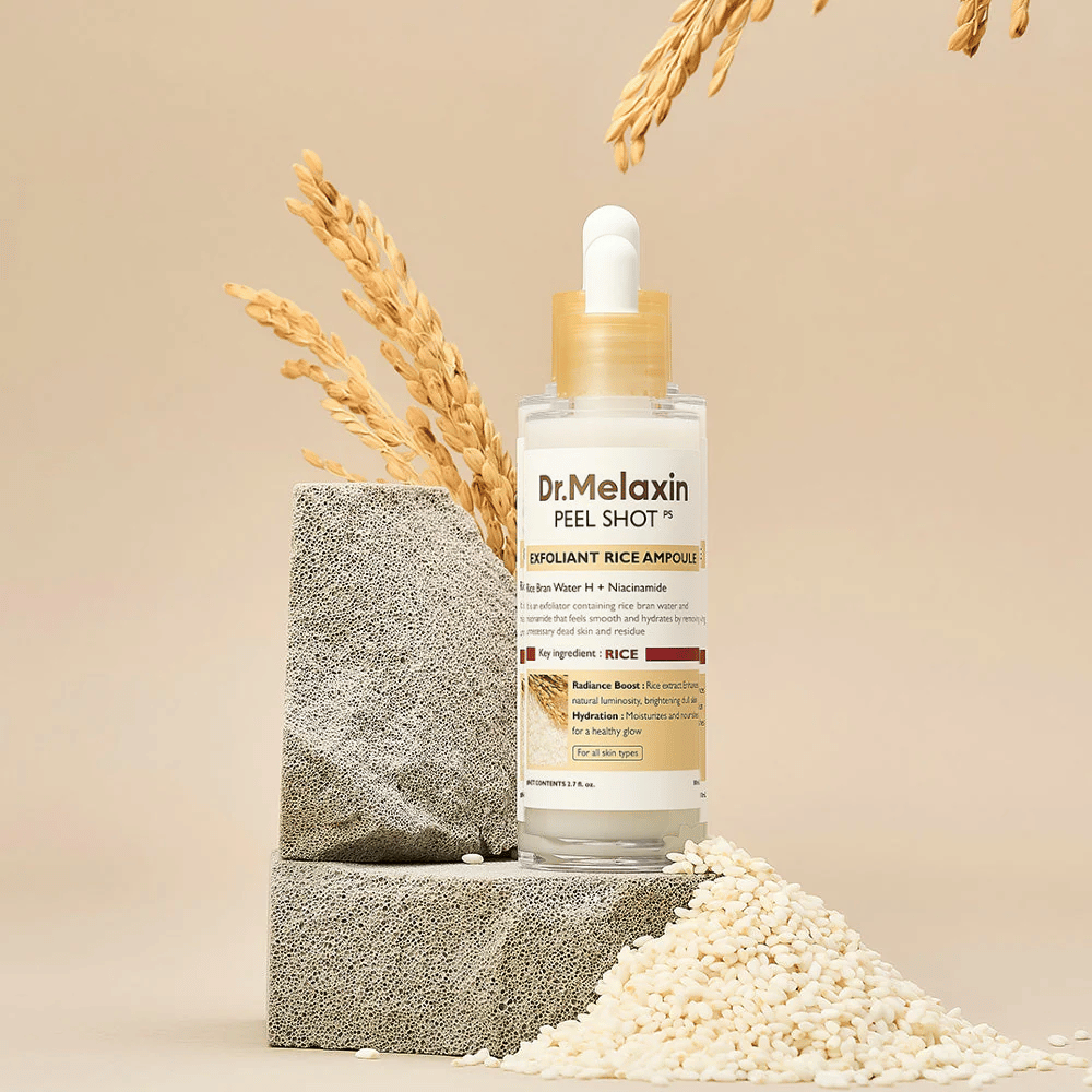 Dr.Melaxin Peel Shot Exfoliant Rice Ampoule set up with rice and stone blocks, Korean exfoliating ampoule with rice extract and niacinamide for clearer and softer skin.