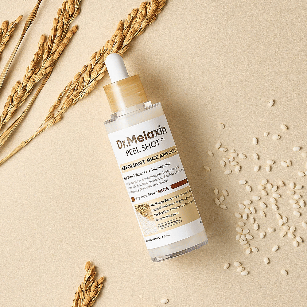 Dr.Melaxin Peel Shot Rice Ampoule lying on a sand-colored surface with rice and ears, exfoliating facial ampoule that combines mild exfoliator with intense moisture.