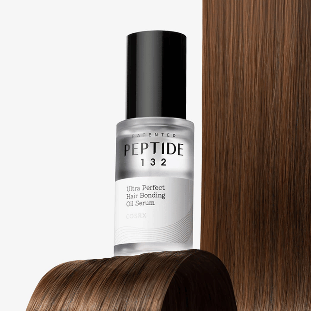 COSRX Peptide 132 Ultra Perfect Hair Bonding Oil Serum placed against shiny hair – provides strength, softness, and shine.