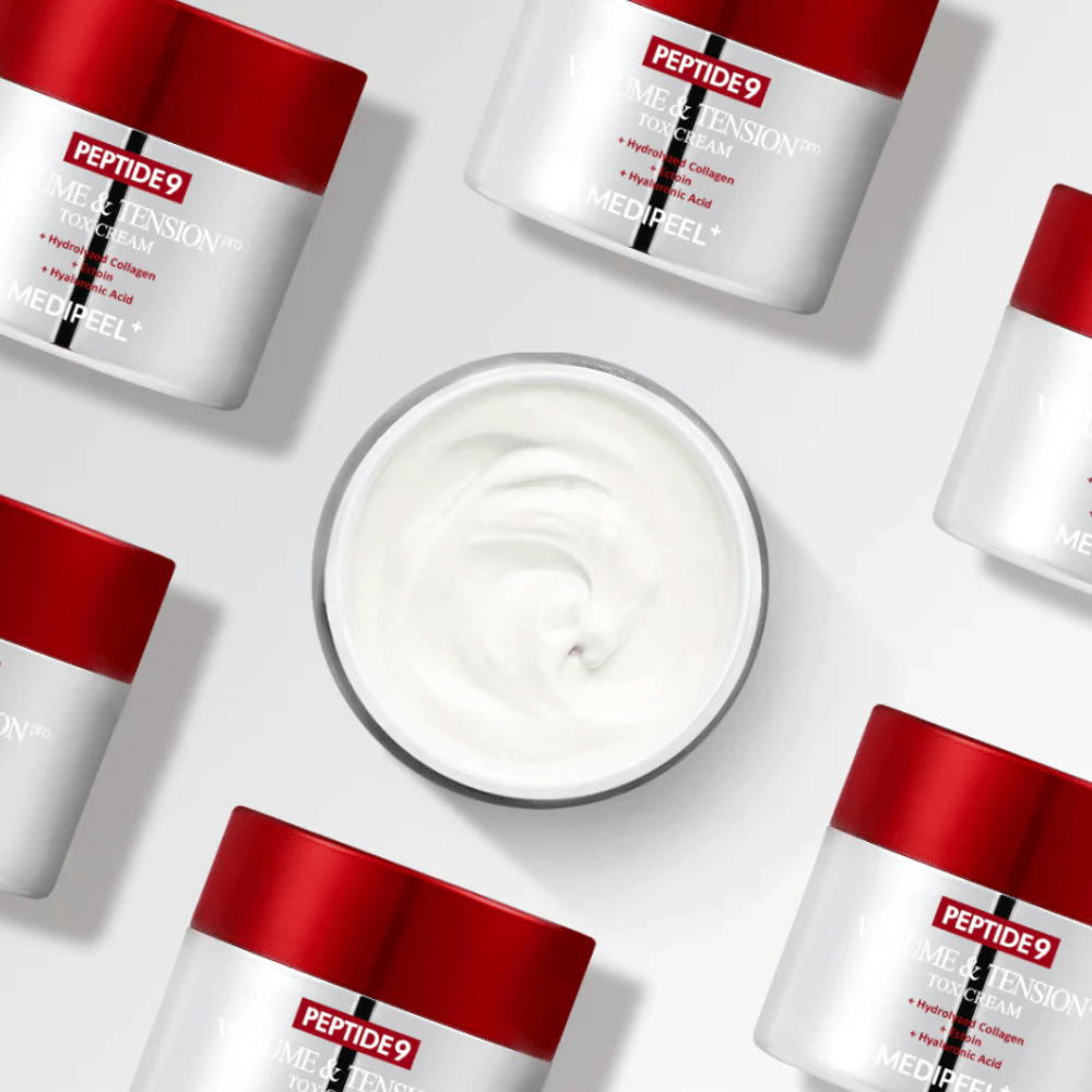Several jars of MEDI-PEEL Peptide 9 Volume & Tension Tox Cream arranged against a white background. The product intensely moisturizes and gives the skin volume and radiance.