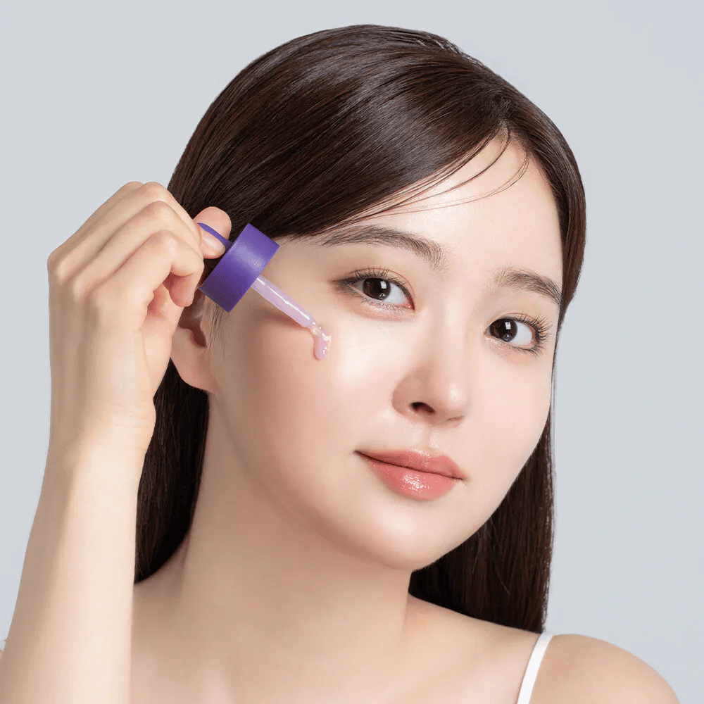 Application of Cellology Purple Carrot Pore Ampoule with dropper on the face for pore care and a more even skin texture.