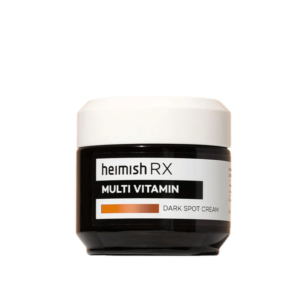 Heimish RX Multi Vitamin Dark Spot Cream in a sleek black jar with a white lid. A face cream enriched with multivitamins, developed to reduce dark spots and even out skin tone.