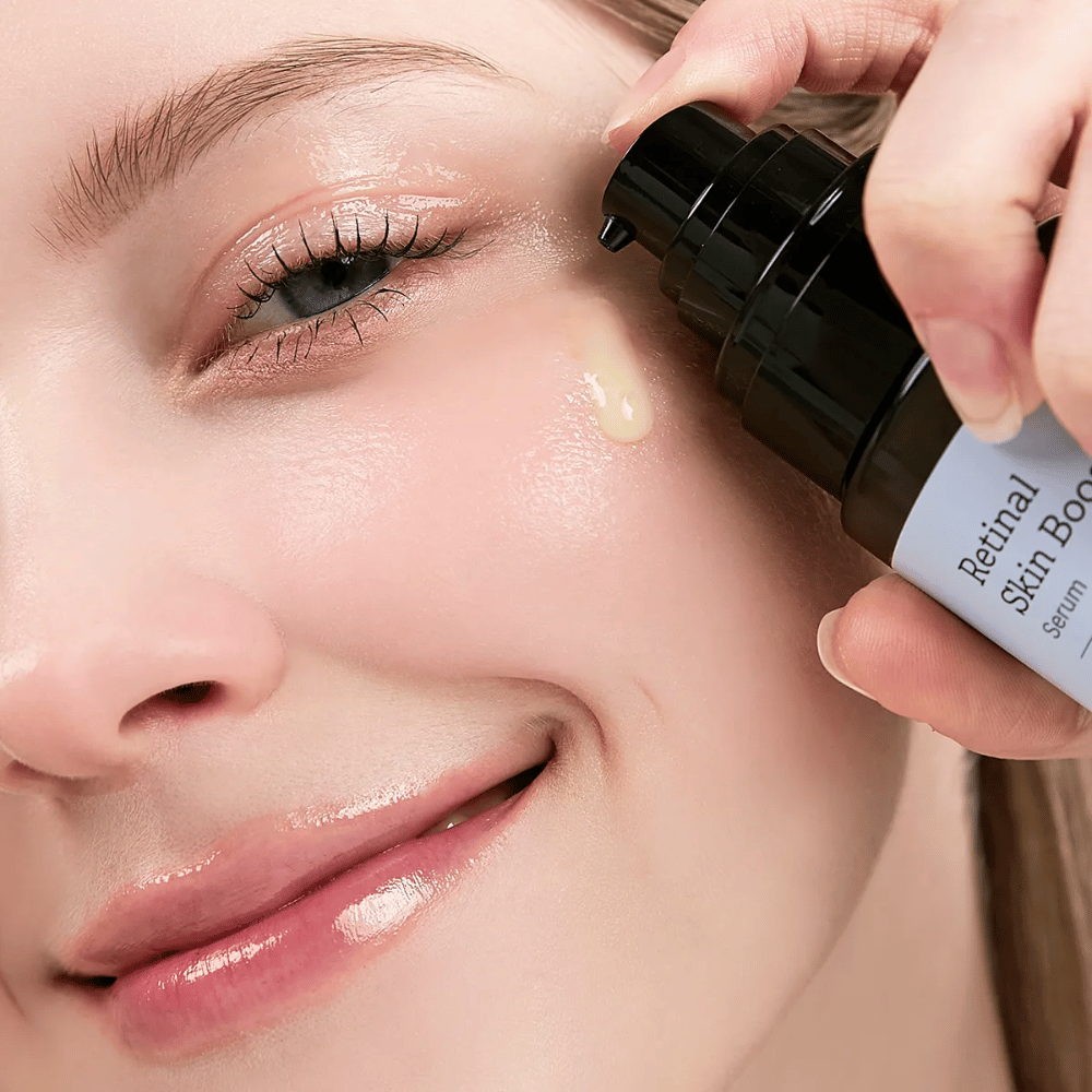 Person applying Meditherapy Retinal Skin Booster Serum near the eye. The serum has a light, yellow tone and gives the skin radiance and firmness.
