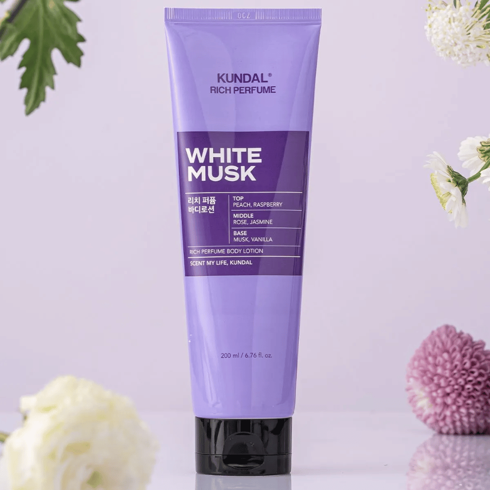 1. KUNDAL Rich Perfume Body Lotion White Musk 200 ml – perfumed body lotion with flowers in the background