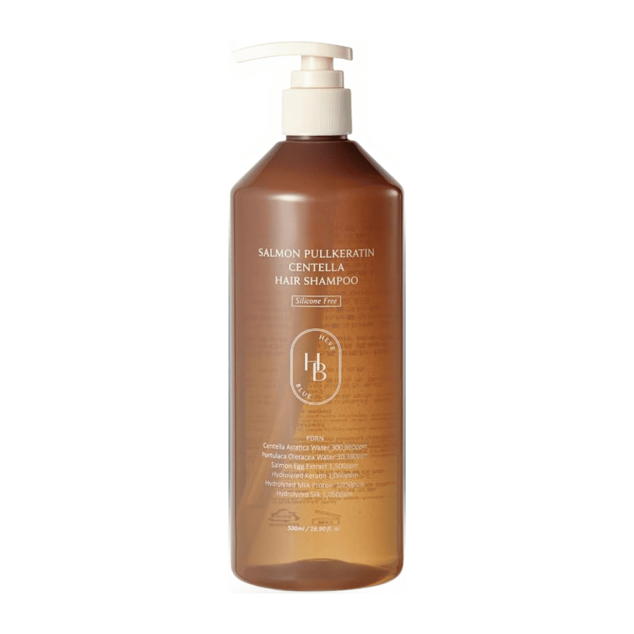 Heveblue Salmon Pullkeratin Centella Hair Shampoo in a transparent brown pump bottle against a light background. Shampoo with centella, salmon extract, and keratin that helps cleanse and care for the hair.