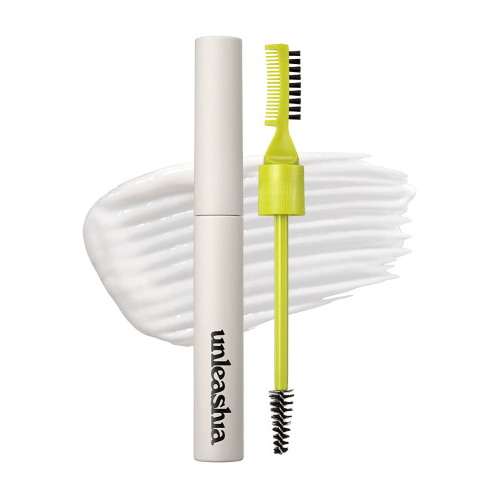 Eyebrow pomade "unleashia" with applicator, green comb, and black brush against a white, wavy background.