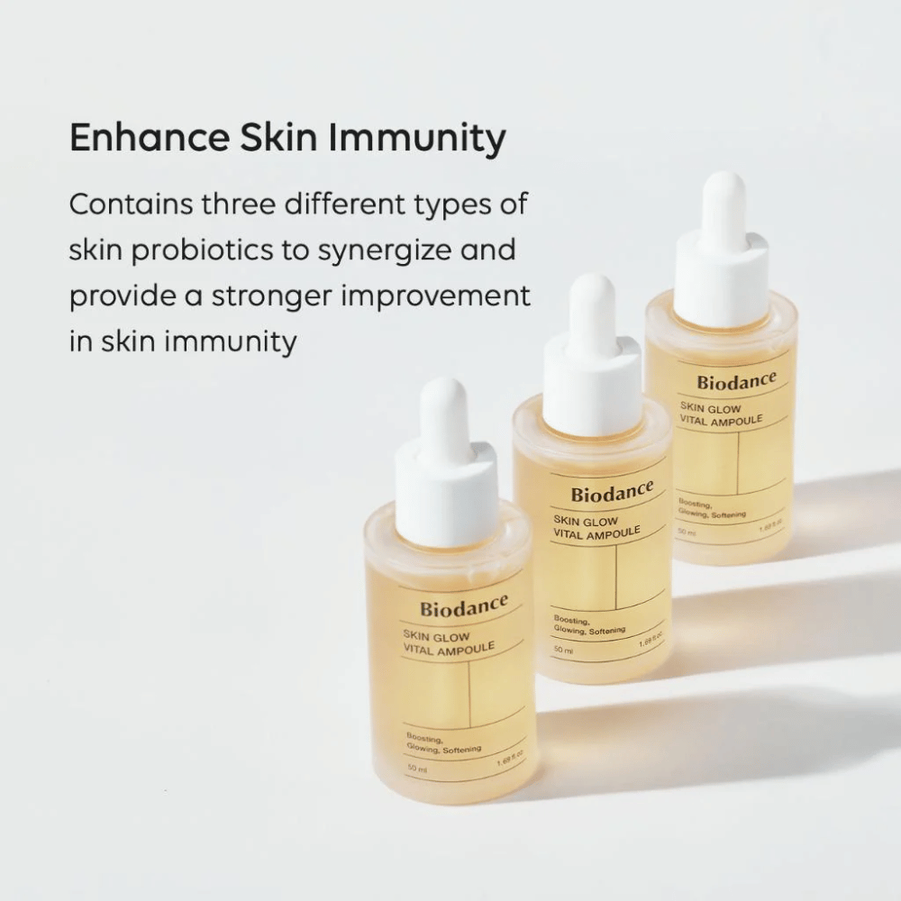 Three bottles of Biodance Skin Glow Vital Ampoule are displayed with the text 'Enhance Skin Immunity'. The product contains three different types of skin probiotics that strengthen the skin's immunity and improve its protection.