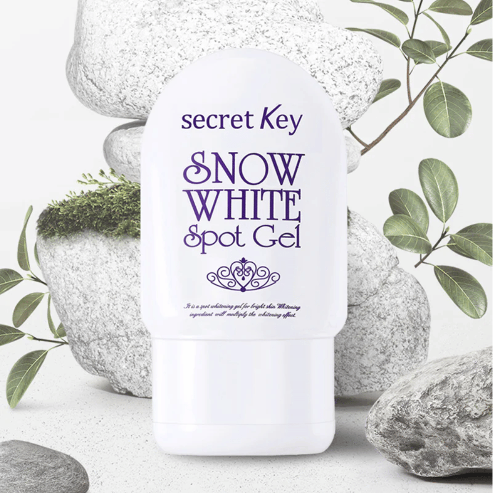 Secret Key Snow White Spot Gel photographed against stones and green leaves.