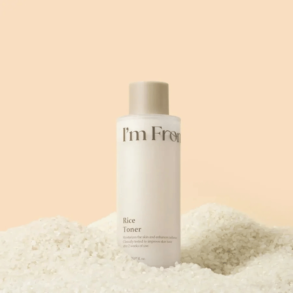 I'm From Rice Toner surrounded by rice that highlights the moisturizing and radiance-boosting formula