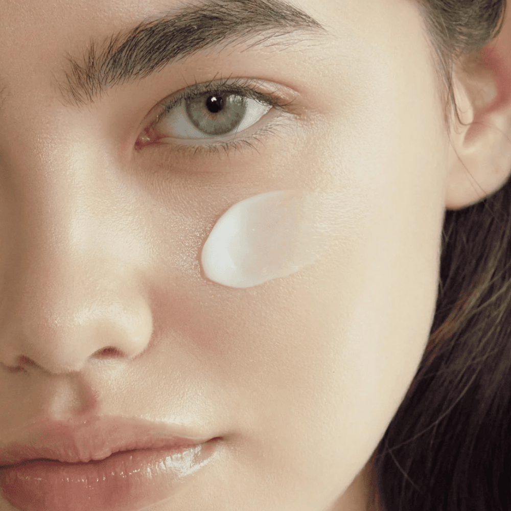 Close-up of skin with the cream applied on the cheek to show the hydrating, softening, and radiance-boosting finish on the skin.