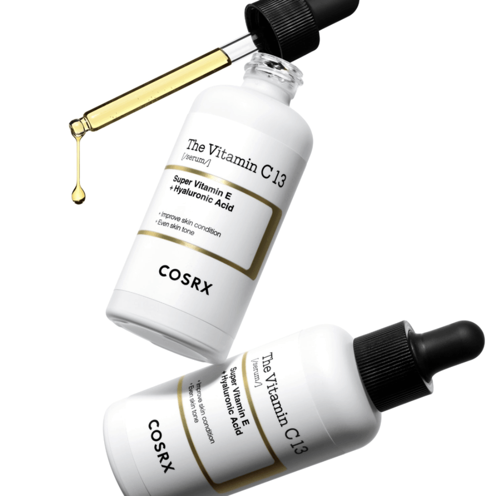 COSRX The Vitamin C 13 Serum 20 ml with pipette and golden serum drop, radiance-enhancing Vitamin C serum for a more even skin tone and improved skin texture.