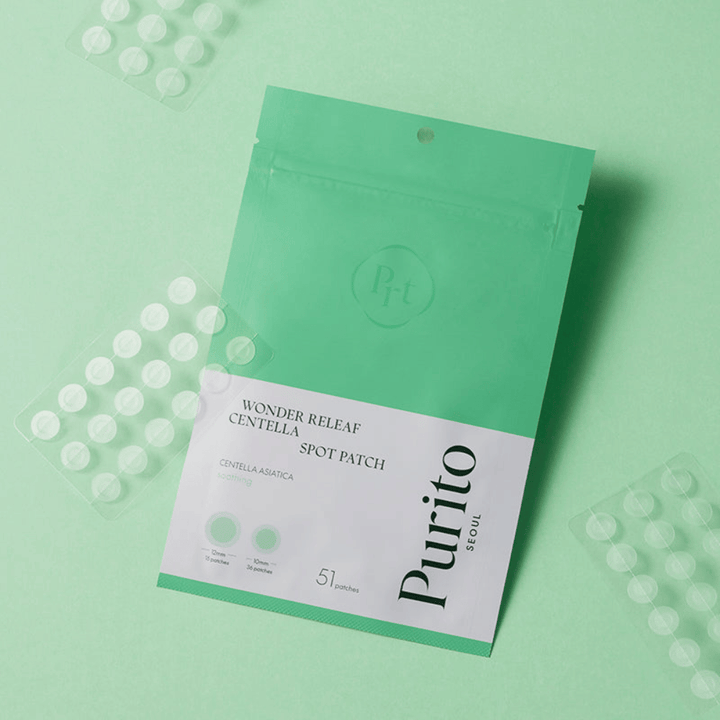 Purito Wonder Releaf Centella Spot Patch on a green background with visible patch sheets, soothing acne patches that reduce redness and protect impurities.