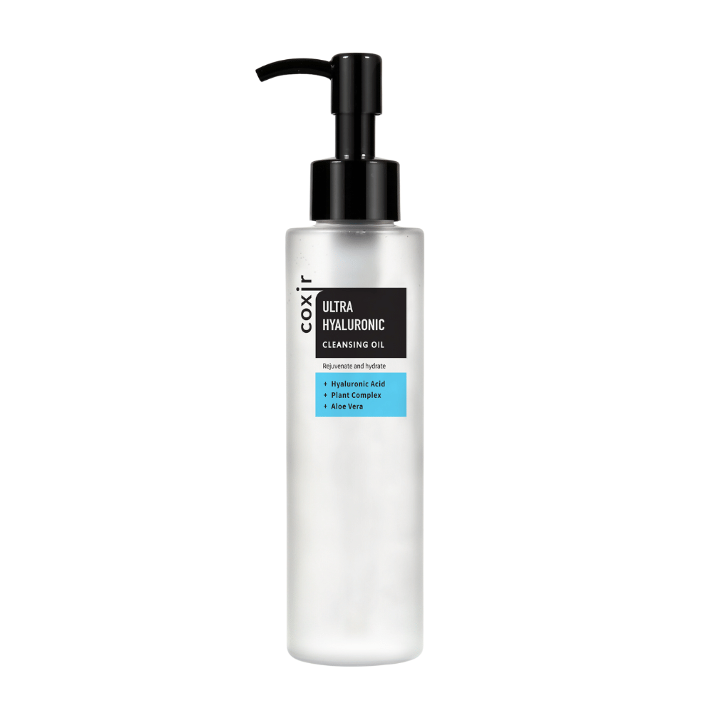 A white pump bottle with the text "coxir ULTRA HYALURONIC CLEANSING OIL", containing hyaluronic acid, plant complex, and aloe vera for hydration and purification.